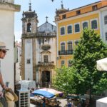 traveller on balcony in Portuguese city