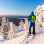 man snowshoeing in snowy lapland