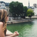 woman looks at river in paris