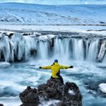 man looking at winter canyon in iceland