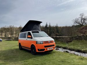 orange campervan in the lake district