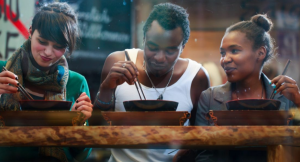 Group of people eating local cuisine to prevent tourism leakage