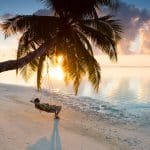 person in a hammock in the maldives