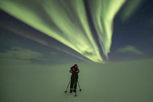 The northern lights floating over snowy Nellim