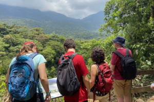 Tourists in Costa Rica looking at a sign