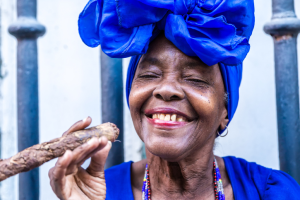 Woman smiling and smoking a cigar in Havana in Cuba