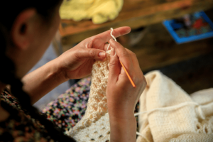 Woman crocheting with a small hook