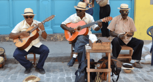 A jazz band with guitar and drummer playing on the streets in Havana, Cuba