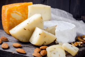 Mix of different cheeses on a plate including Camembert 