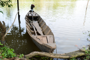 Sampan boat docked in southeastern Vietnam with small motor attached