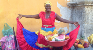 Woman holiding up her bright and colourful skirt in Havana Cuba