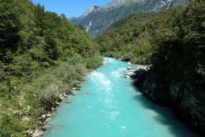 The Soca River flowing through the Slovenian countryside